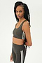 Side view of girl wearing light dark grey sports bra with two thin white stripes down the side and light dark grey leggings