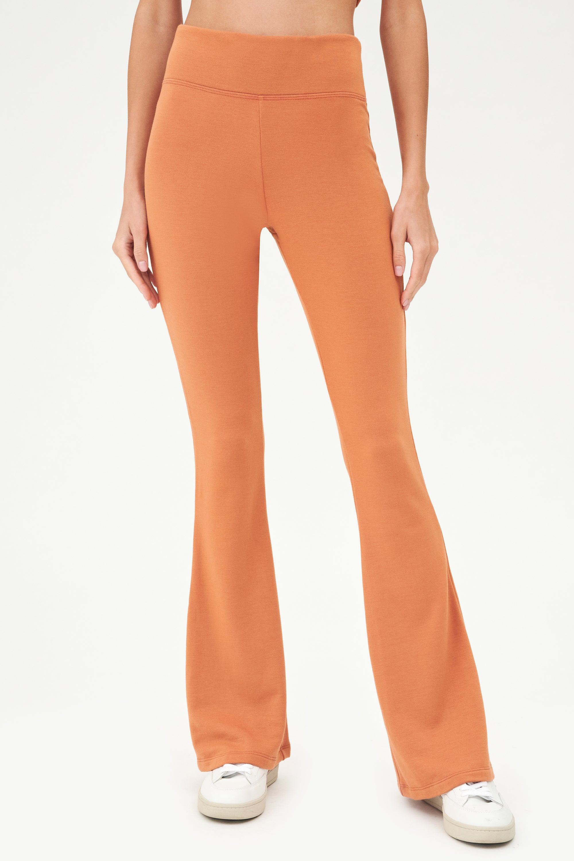 A woman wearing comfy, casual-chic Raquel Fleece Flare - Pecan leggings by SPLITS59.