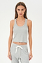 A woman stands against a plain background, wearing the SPLITS59 Ashby Rib Crop tank top in grey with matching drawstring sweatpants, looking directly at the camera with her arms relaxed by her sides.