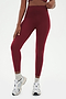Front view of girl wearing highwasited dark red leggings with grey shoes