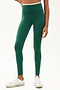 Frot view of girl wearing green leggings with thin white band around waist with white shoes