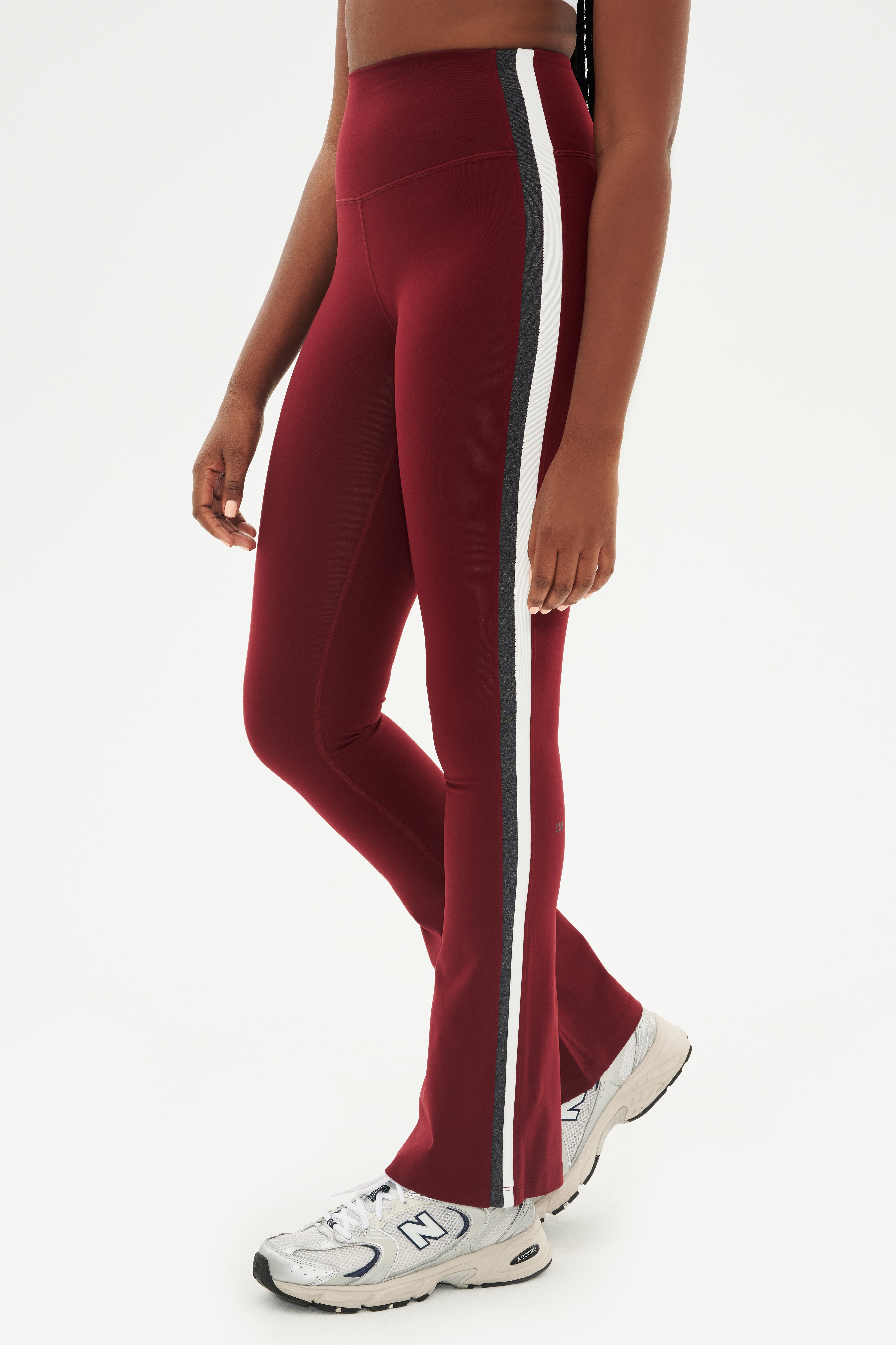 A woman wearing Raquel High Waist Flared Legging in Bordeaux/Heather Grey/White by SPLITS59.