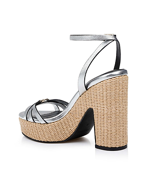 The Genevra Platform Sandal features metallic silver Nappa leather straps, a thick woven platform heel, and an ankle buckle strap, shown in a side view against a white background.