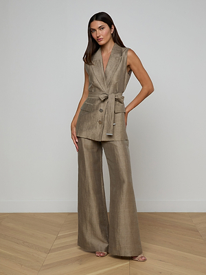 A woman with long brown hair poses confidently in a neutral-toned room wearing the Harper Linen-Blend Vest with matching wide-leg pants and a tie belt, her hand resting on her hip.