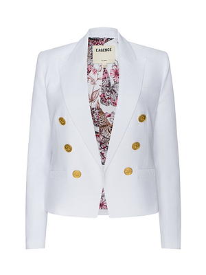 The Brooke Blazer is a white double-breasted jacket in ribbed ottoman fabric, featuring gold buttons, peaked lapels, a floral patterned lining, and an inner collar label displaying LAGENCE.