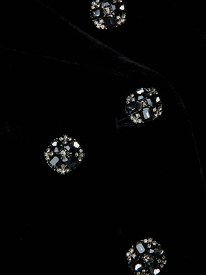 A close-up of the L'AGENCE Bethany Velvet Blazer highlights round buttons adorned with sparkling black and silver gemstones.
