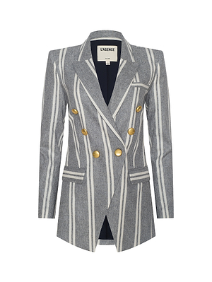 The Kendi Longline Blazer features bold white and gray vertical stripes, gold buttons, notched lapels, a chest pocket, and is crafted from an Italian wool blend. The inner label reads LAGENCE.