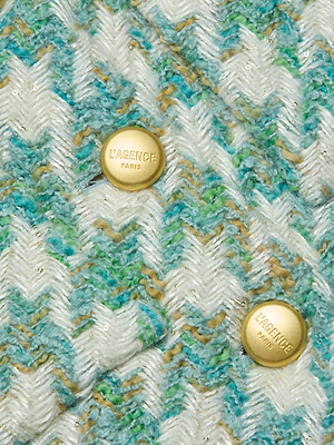 Close-up of the Jia Houndstooth Tweed Jacket for women, featuring three-quarter sleeves, textured houndstooth fabric in white, teal, jade green, and tan, and two gold L’AGENCE PARIS-engraved buttons.
