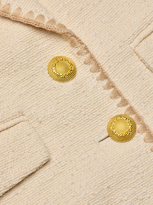 Close-up of the Wylla Tweed Blazer in ecru, showcasing textured fabric, scalloped embroidered trim, gold decorative buttons, and a flap pocket.