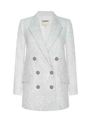 The Cambrie Oversized Sequin Blazer, a silver double-breasted design with notched lapels and front flap pockets, shines with cinematic flair on a white background. Featured in the After Hours collection.