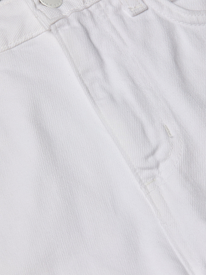 Close-up of the Lissania Jean Short in white denim, highlighting the front pocket, waistband, silver button, tailored fit, fabric texture, and precise stitching.