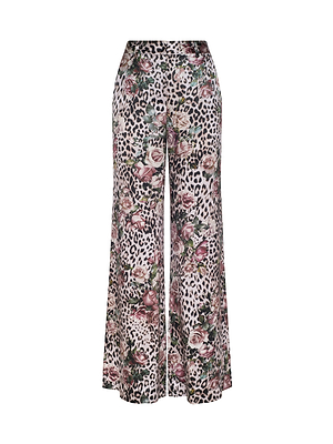 The Pilar Silk Wide-Leg Pant features a high-rise fit and floral designs, combining elegance with playful style.