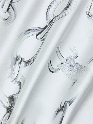A close-up of glossy silk charmeuse in light grey with silver metallic chain print, featuring soft, light-catching folds—ideal for crafting the elegant Gavin Silk Wide-Leg Pant.