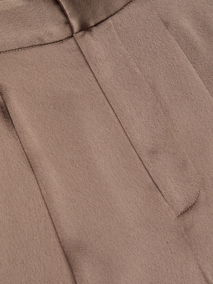 Close-up of cardamon brown, soft-textured fabric with visible stitching and a seam, from the Aubrie Satin Pant.