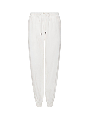 The Mariko Jogger, made from water-repellent ivory nylon, features an elastic waistband, drawstring, and elastic cuffs, shown against a plain white background.