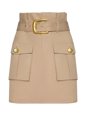 The Maelis Paperbag Mini Skirt features a beige hue, high-rise waist, wide matching belt with a large gold buckle, plus two front flap cargo pockets accented by gold buttons.