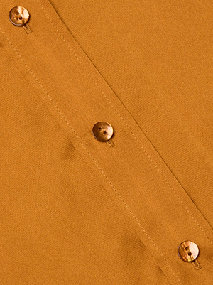 Close-up of the Dani Silk Blouse by L'AGENCE shows brown silk fabric with a seam and three marbled buttons sewn vertically. The material’s texture and stitching are clearly visible.