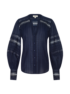 The Kiera Blouse is a navy blue bohemian top with a vertical ribbed texture, cotton-blend jacquard lace panels on the shoulders and sleeves, a button-down front, V-neckline, and voluminous sleeves with lace detailing near the cuffs.