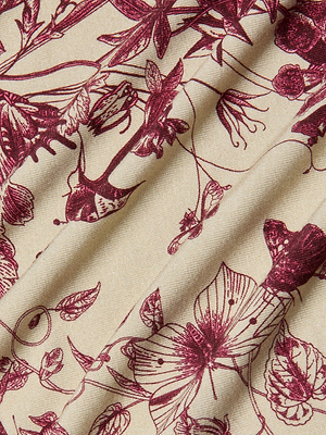 The Ressi Fitted Tee showcases a beige fabric with an intricate maroon floral and butterfly toile print, featuring various flowers, leaves, and stems for a soft texture and elegant look.