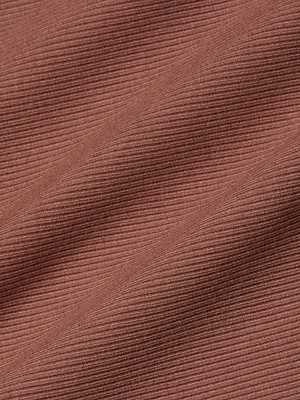 A close-up of the Adira Scoopneck Tank's stretch rib fabric in reddish-brown, showing fine horizontal lines and gentle folds that emphasize its soft, textured look.