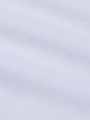 Close-up of the Scarlet Scoopneck Tee by L'AGENCE, featuring white stretch jersey fabric with a subtle diagonal ribbed texture and gentle wavy lines for a soft, minimal pattern.