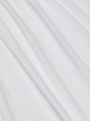Close-up of the smooth, white fabric on the Cassandra Ruched Bodysuit, showing soft diagonal folds and gentle shadows that highlight its comfortable texture and elegant flow.