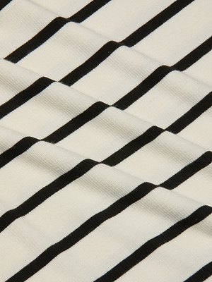 A close-up of the Nura Racerback Midi Dress shows white fabric with evenly spaced black horizontal stripes and slight diagonal wrinkles, highlighting its classic striped day dress design.