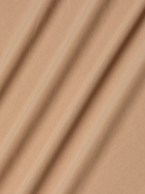A close-up of light brown stretch jersey fabric with gentle folds and subtle shadows, used in the Raye Slip Lining Dress—perfect for adjustable strap designs.