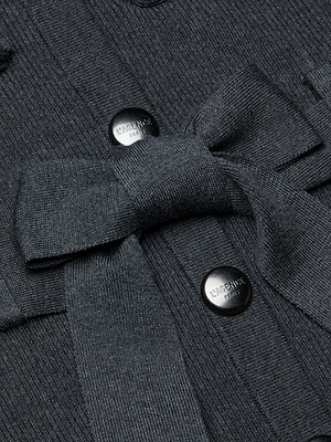 Close-up of the Lore Cardigan, a dark gray ribbed knit sweater with a tie belt and two black buttons engraved with LAGENCE.