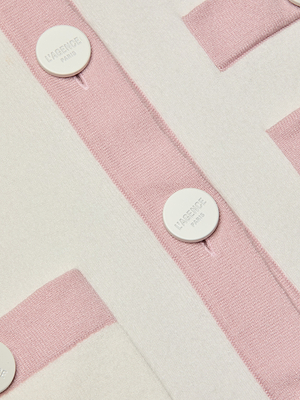 Close-up of the Nomi Satin Back Cardigan's light pink and white striped fabric with “L’AGENCE PARIS” embossed white buttons, and contrast trim highlights its soft, textured look.
