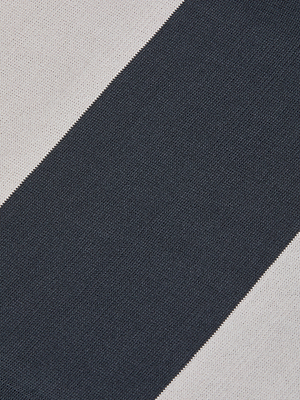 Close-up of the Berlin Duster Cardigan fabric, featuring alternating diagonal black and off-white stripes. The soft, woven texture is perfect for cozy styles with a long silhouette.