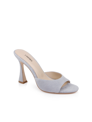 The Avery Suede Open-Toe Mule in pale blue features a sculpted curved heel, beige memory foam insole, and LAGENCE branding on the footbed, displayed against a white background.