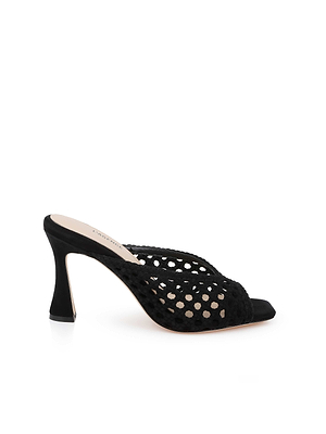 The Jacques Suede Mule features black suede, a sculptural flared heel, open toe, and a woven see-through mesh upper. Displayed against a white background.