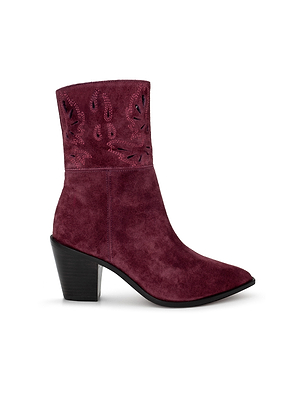 The Anne Western Bootie features maroon suede, a pointed toe, chunky black heel, mid-calf height, and decorative cutout patterns near the top.