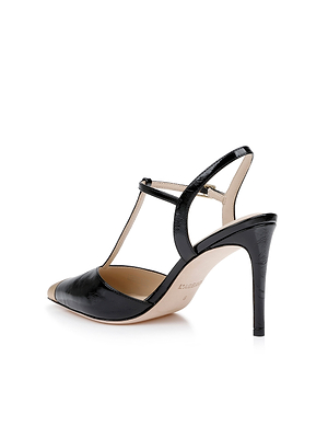 The Kaveh Slingback Pump in black patent leather features a pointed toe, T-strap design, and stiletto heel, displayed from a rear side angle on a white background.