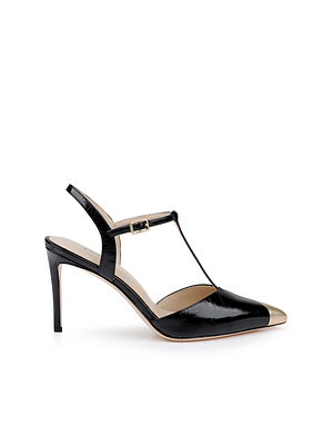 The Kaveh Slingback Pump is a black patent leather shoe with a gold pointed toe, T-strap design, stiletto heel, and small ankle buckle, shown against a white background.