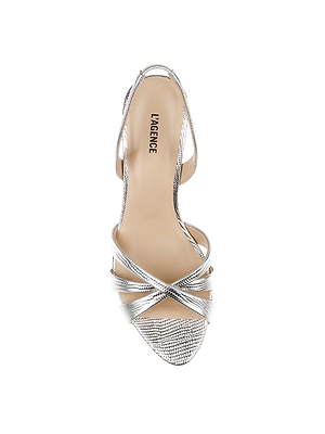 Top view of the Colwill Slingback Sandal: a stylish silver design with crisscross toe straps, open back, mid heel, lizard-embossed texture, and LA RENCE branding on the tan insole.