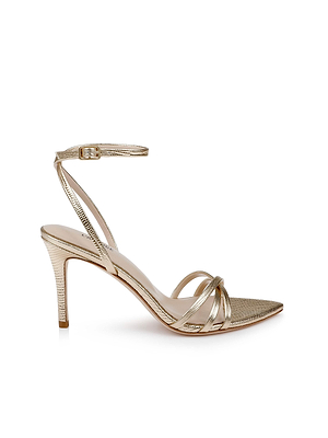 The Dua Leather Sandal features gold lizard-embossed leather, strappy design, ankle strap with buckle, open toe, and a slim stiletto heel, shown against a white background.