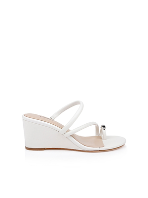 The Maritza Wedge Sandal is a white, minimalist wedge with an open toe, two thin foot straps, toe loop, metallic accent, memory foam insole, and a medium-height heel for comfortable style.