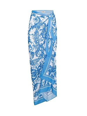 The Maribel Cover-Up Pareo is a wrap-style skirt in blue baroque with an ornate floral print, tie waist detail, and a flowing asymmetrical hem, adding vintage glamour.