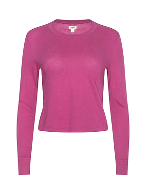 The Zeva Tee, a magenta long-sleeve crew neck with a semi-relaxed fit and fitted shape, features a simple, unadorned design and is displayed against a white background.