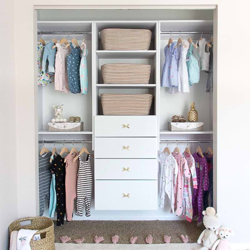 Closet organizer for a toddler with hanging clothes and drawers