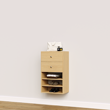 Natural oak closet drawers with slab fronts and shelves for linens, towels, and folded clothing.