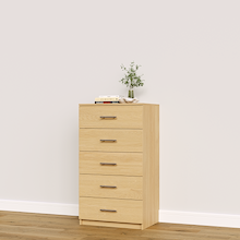 Natural oak drawer cabinet with slab fronts for linens, towels, and folded clothing.
