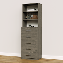 Grey slab 5-drawer closet tower module with five deep drawers and three upper display shelves for folded clothing storage.