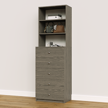 Grey slab 5-drawer closet tower module with five deep drawers and three upper display shelves for folded clothing storage.