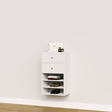White closet drawer unit with slab fronts and shelves for folded clothes and wardrobe storage.
