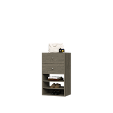 Grey closet drawer unit with slab fronts and shelves for jewelry and accessory storage.