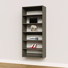 Grey 30 inch closet shelf tower for upright storage in a master bedroom.