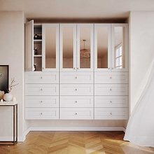 White 31.5 inch half closet doors with mirror panels fully installed in a luxury walk-in closet for a built-in look.